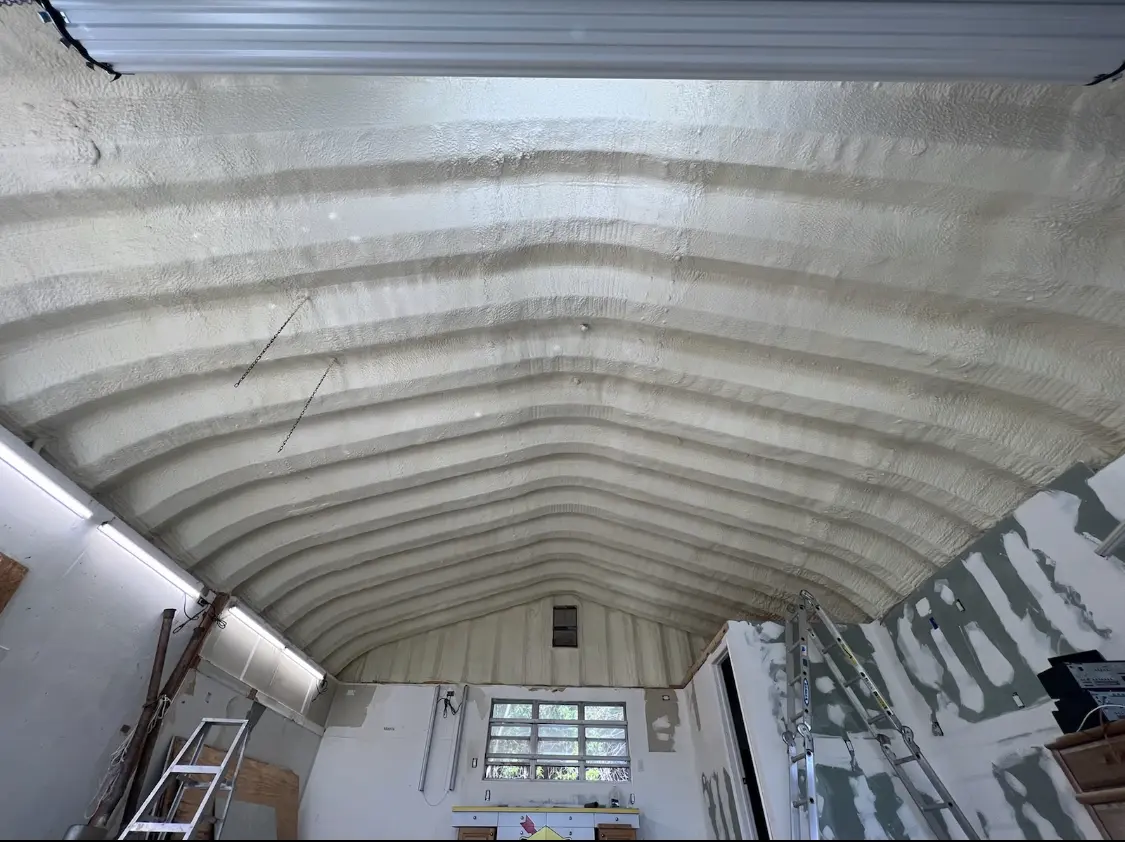 Spray polyurethane foam applied to the underside of a metal roof deck in Putnam